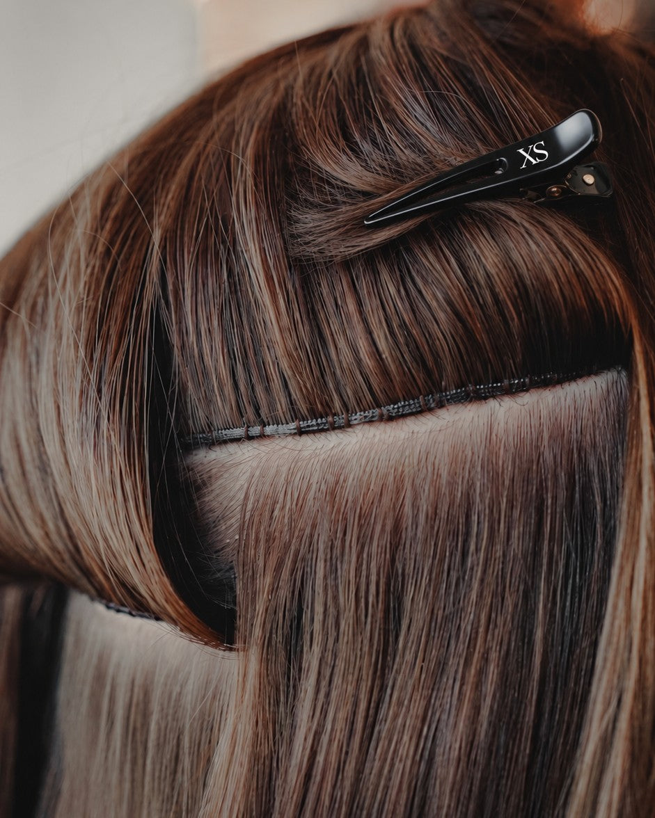 Close-up of Genius Weft hair extensions for professional salon installs